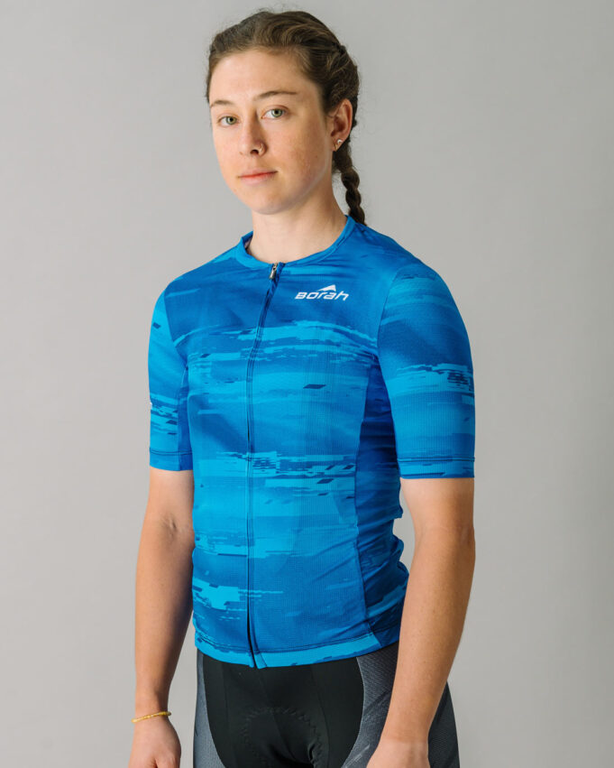 Front view of a female model wearing a blue custom Women's OTW Cycling Jersey.