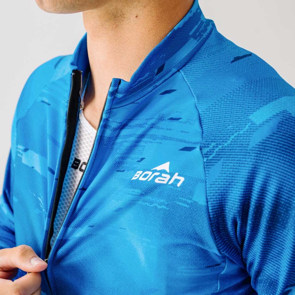 Athlete unzipping the Team Long Sleeve Cycling Jersey.