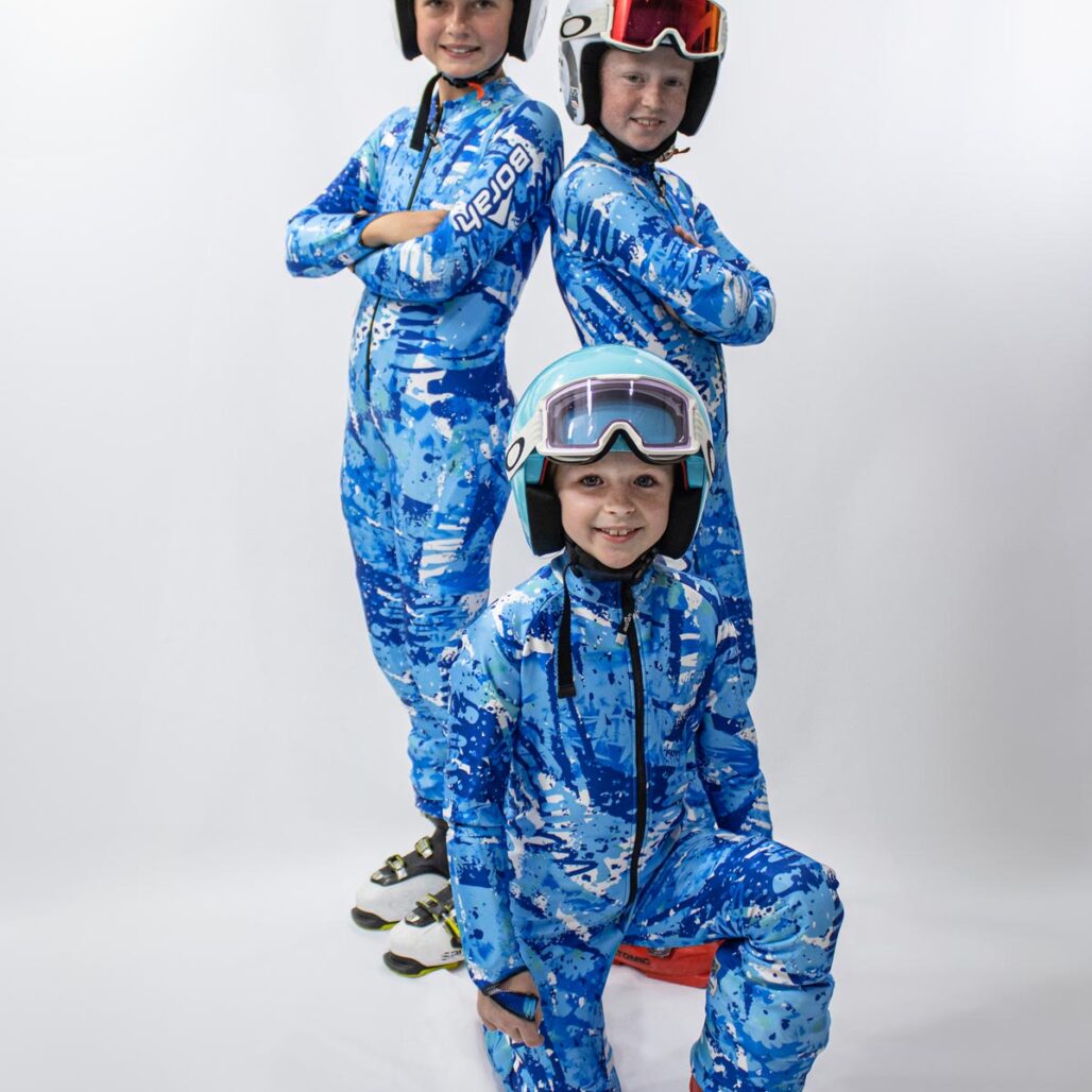 Three young alpine skiers posing in thier custom alpine race suits by Borah.