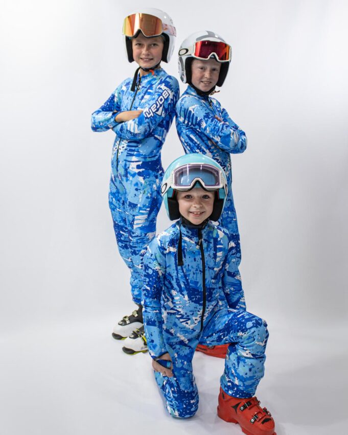 Three young alpine skiers posing in thier custom alpine race suits by Borah.