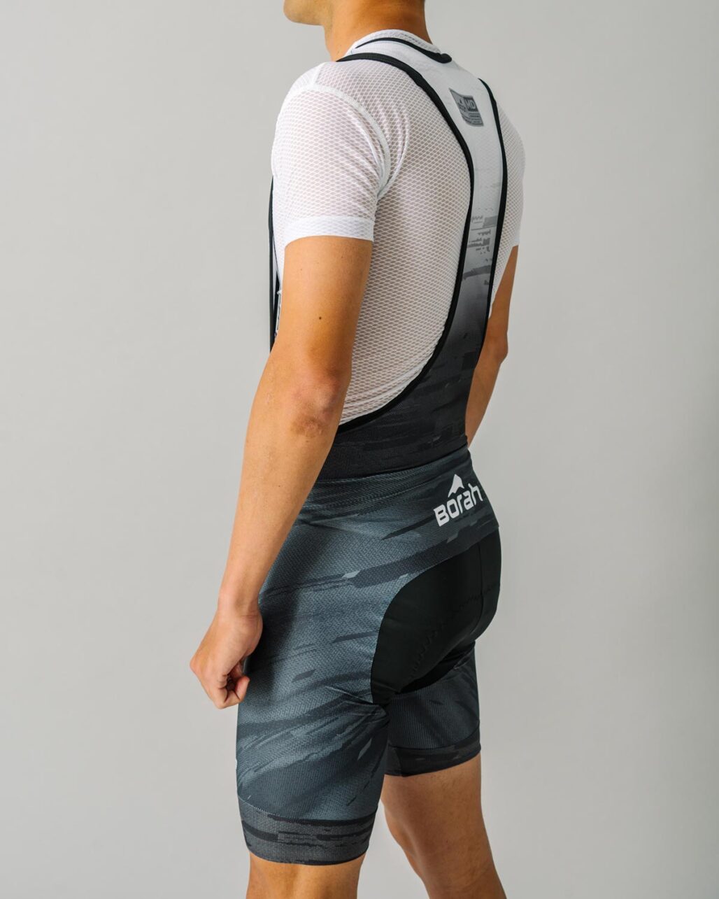 Model wearing a Men's OTW Cycling Bib side view.