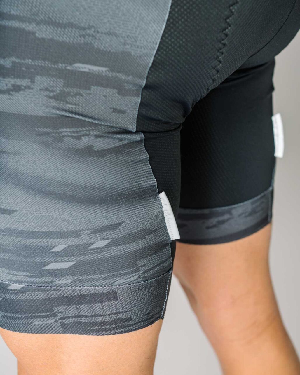 Men's OTW Spark Cycling Bib reflective tabs detail view.
