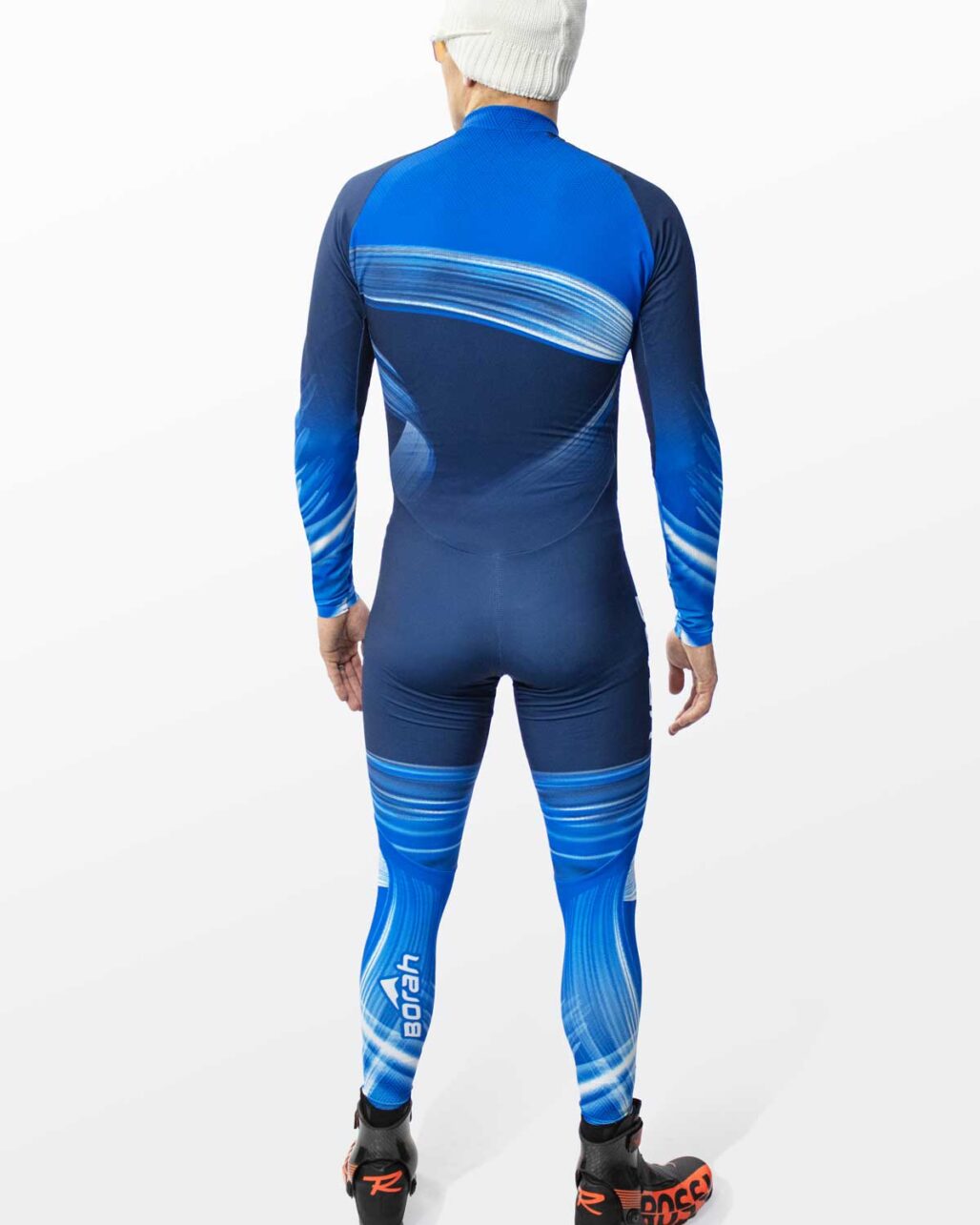 Model posing in the Men's OTW One Piece XC Suit back view.