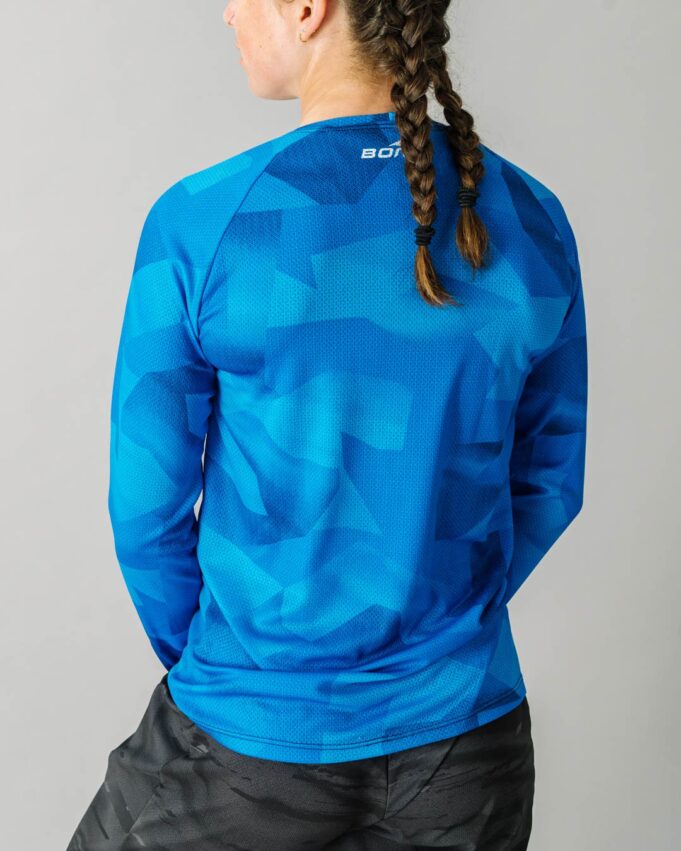 Back facing photo of a female wearing the new Women's Pro Long Sleeve Freeride MTB Jersey.