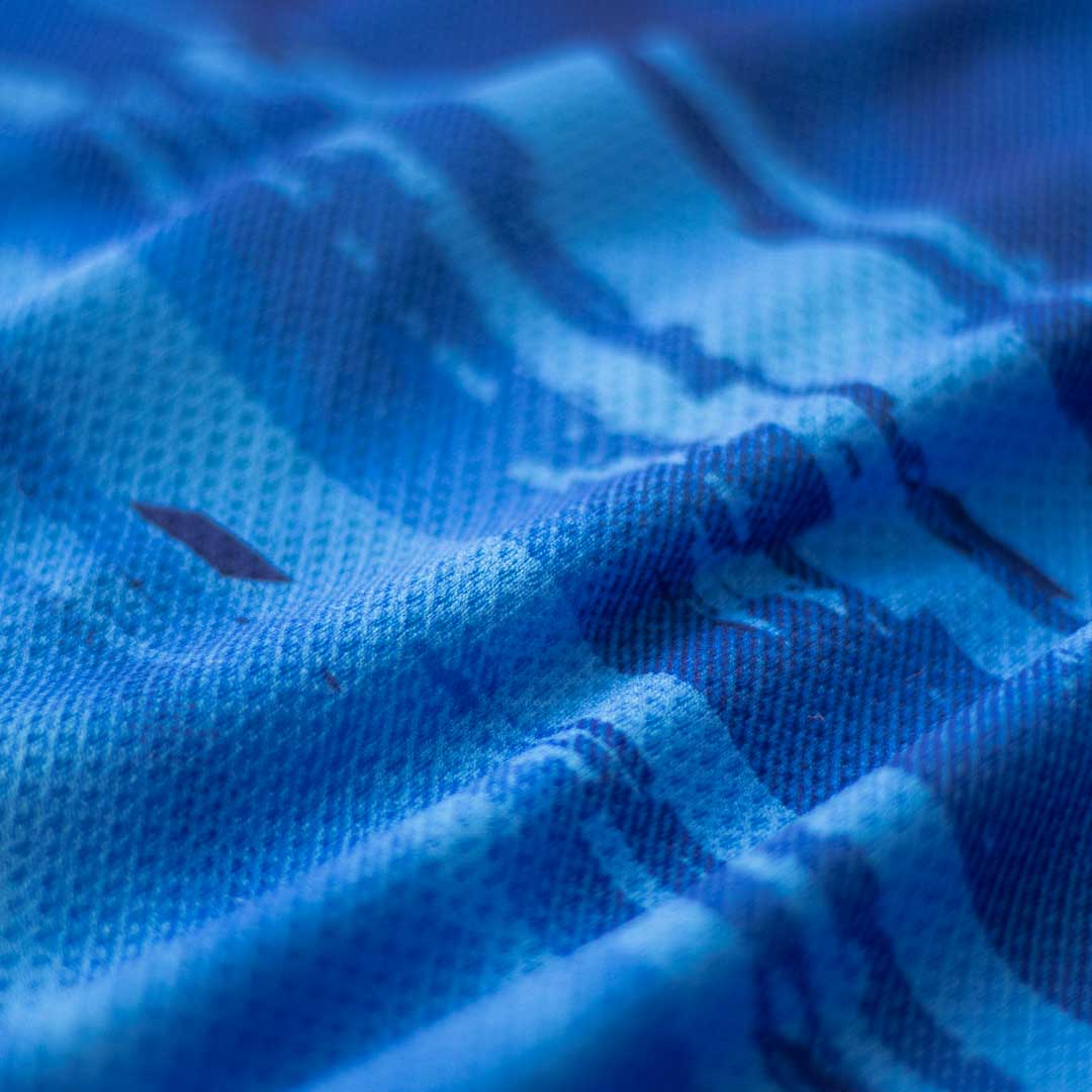Detail photo of a swatch of blue high-performance sublimation fabric.
