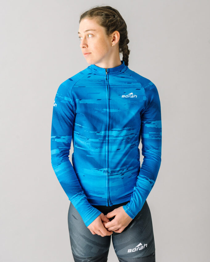 Front view of a female model wearing a blue custom Women's Team Long Sleeve Cycling Jersey.
