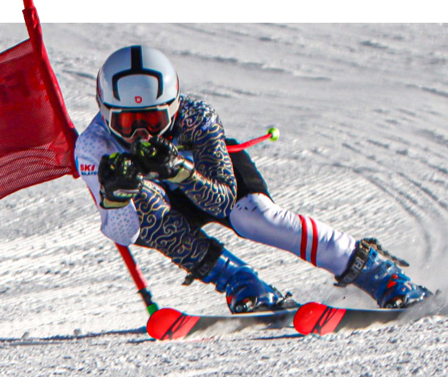 Alpine skier racing past a gate.