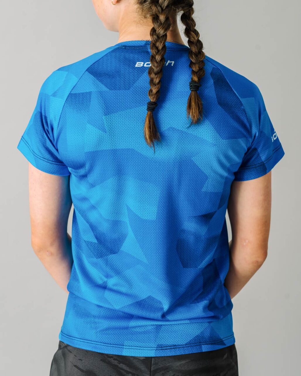 Back facing photo of a female wearing the new Women's Pro Freeride MTB Jersey.