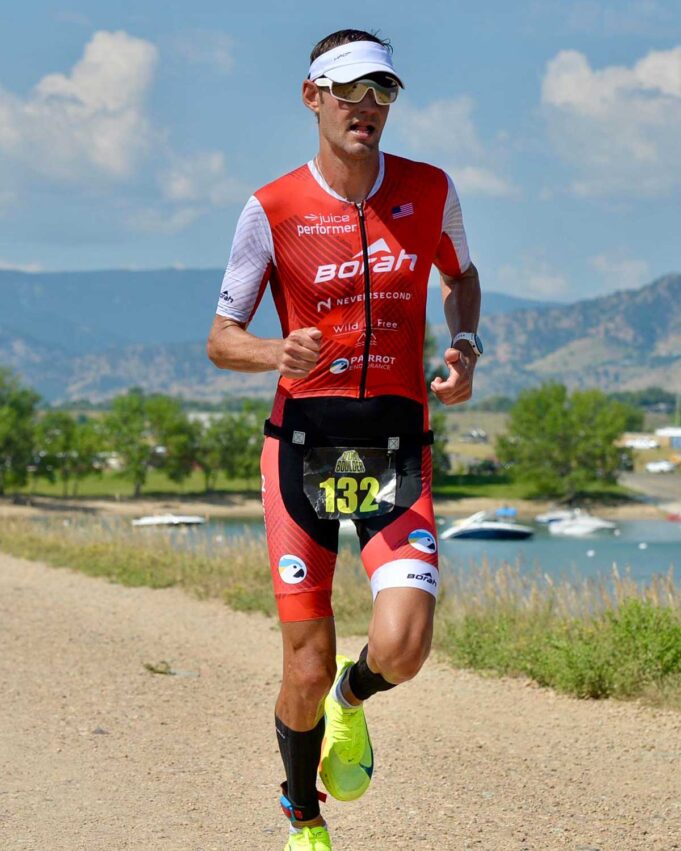 Athlete running down a gravel path wearing a custom OTW Turbo Tri Skinsuit.