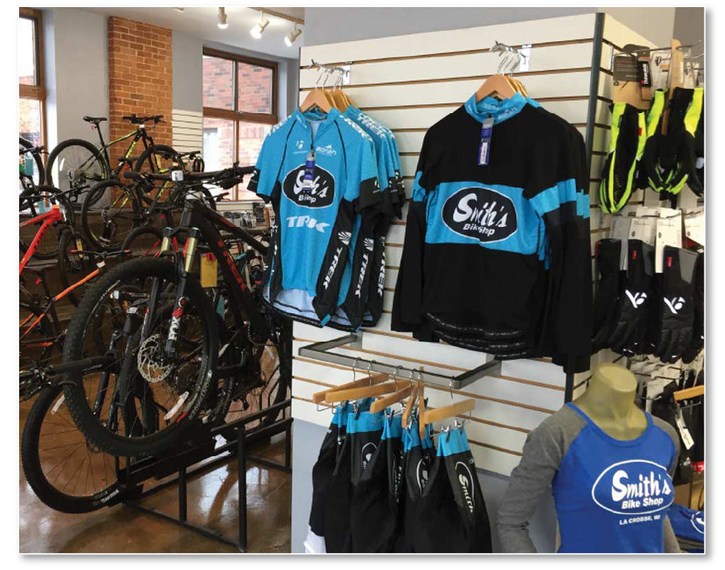 Bike shop shelves with custom cycling jerseys and apparel by Borah Teamwear.