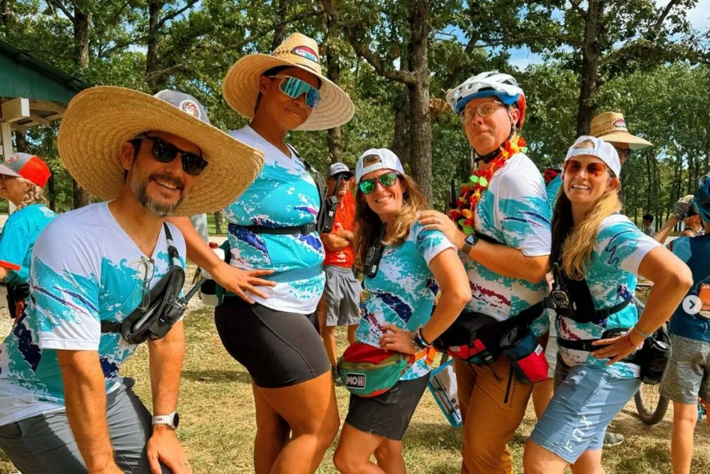 A group of athletes showing their team spirit while sporting their new custom cycling kits that all match.